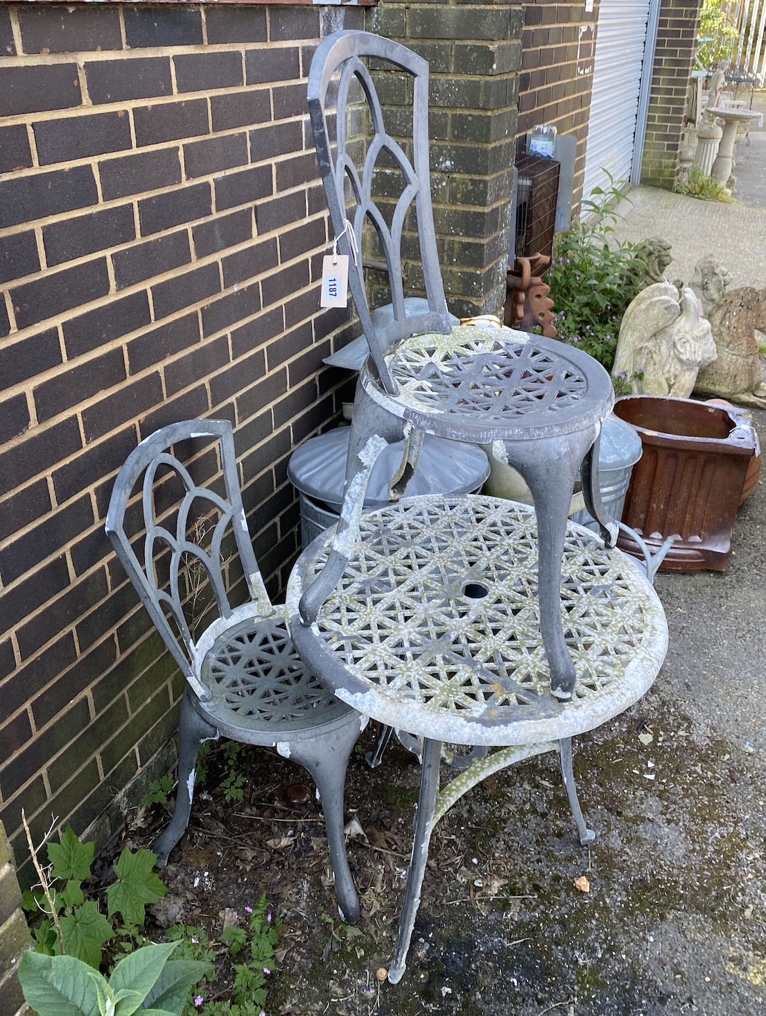 An aluminium circular garden table, 66cm diameter, and a pair of chairs